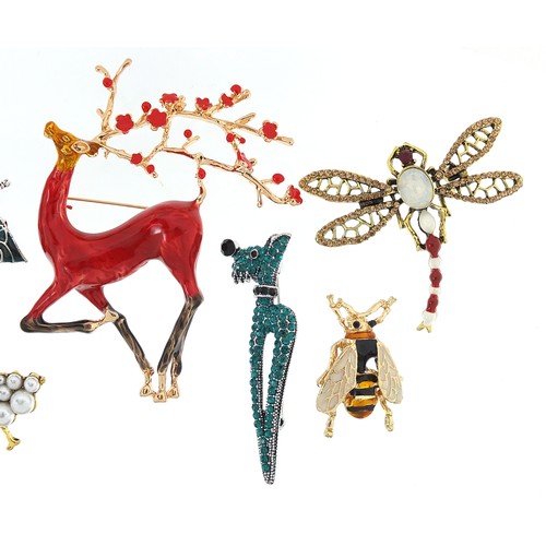 1112A - Seven jewelled and enamel animal and insect brooches including stag, owl, dragonfly and dog, the lar... 