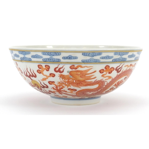 393 - Chinese blue and white with iron red porcelain bowl hand painted with dragons chasing a flaming pear... 