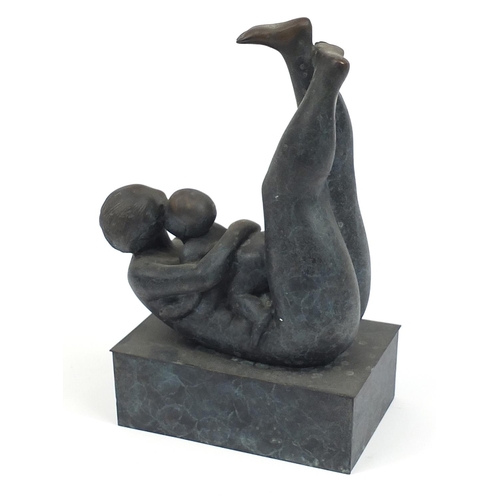 19 - Mid century style patinated bronze study of a mother and child raised on a rectangular block base, 3... 