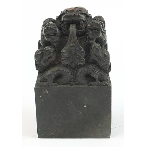 293 - Large Chinese patinated bronze dragon seal, character marks to the base, 13.5cm high