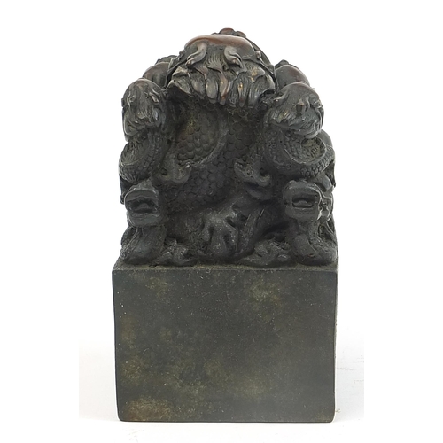 293 - Large Chinese patinated bronze dragon seal, character marks to the base, 13.5cm high