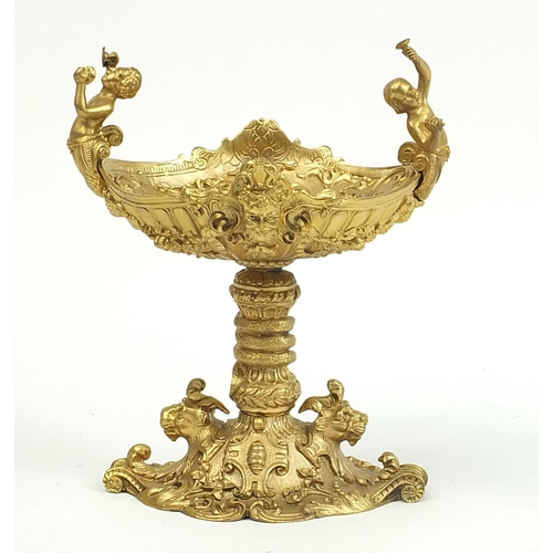 294 - Gilt bronze pedestal dish with animal heads and mermaid handles, 22cm high