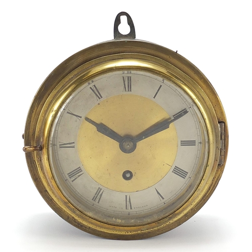 297 - Brass ship's bulkhead design wall clock with silvered chapter ring, having Arabic numerals, 18cm in ... 