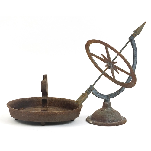 1421 - Victorian cast iron boot scraper and a painted metal sundial, the largest 35cm high