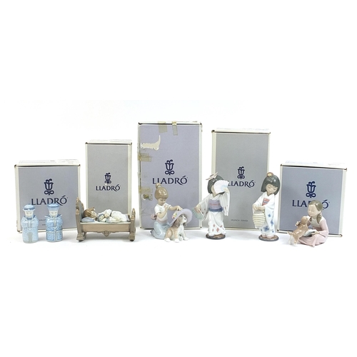 390 - Five Lladro porcelain figures and a pair of Chinese porcelain Chinaman salt and pepper casters, the ... 