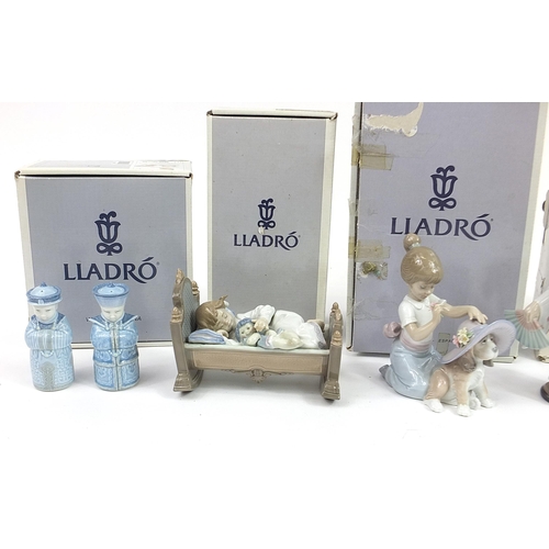 390 - Five Lladro porcelain figures and a pair of Chinese porcelain Chinaman salt and pepper casters, the ... 