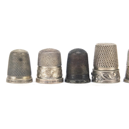 311 - Eight silver and white metal thimbles, various hallmarks, the largest 2.4cm high, 35.6g