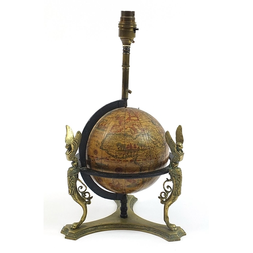 27 - Antique brass rotating globe design table lamp with griffins and paw feet, 39cm high including the f... 