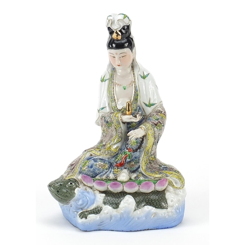 65 - Chinese porcelain figure of Guanyin riding a tortoise hand painted with flowers, 29cm high