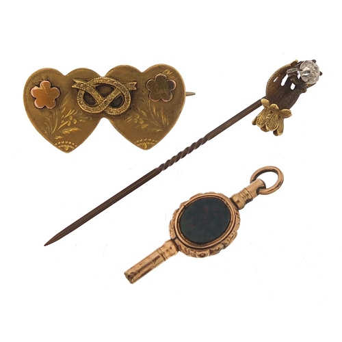 946 - Antique gold coloured metal jewellery comprising a hardstone watch key, double love heart sweetheart... 