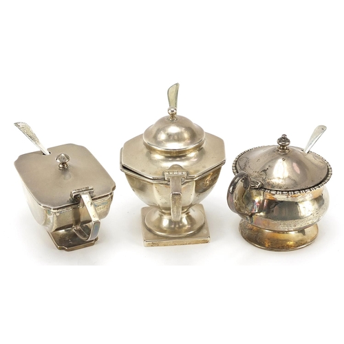 98 - Three Edwardian and later silver mustards with blue glass liners, two with silver spoons and one sil... 