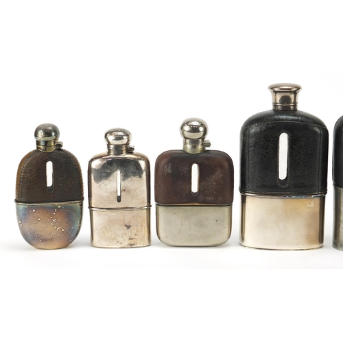 319 - Six antique and later hip flasks, five with leather mounts, the largest 18cm high