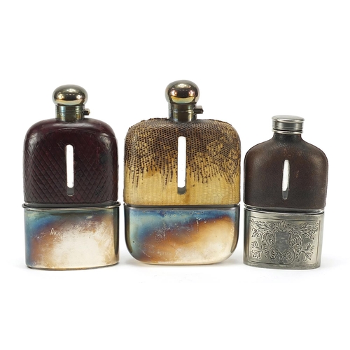 320 - Three antique glass hip flasks with silver plated, snake skin and leather mounts, the largest 18cm h... 