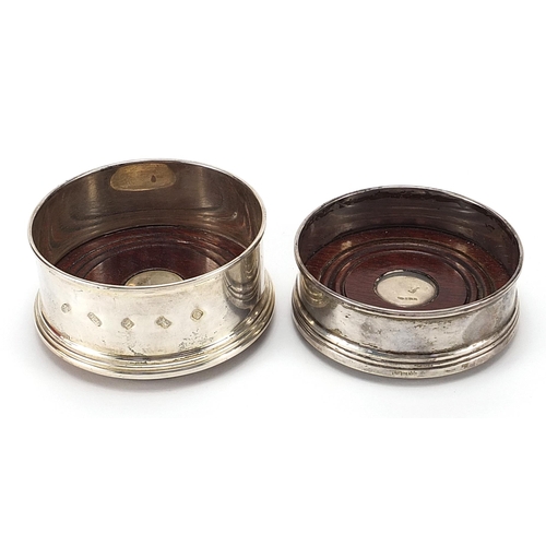 139 - Two circular silver and oak wine coasters, the largest 9cm in diameter, total weight 196.2g