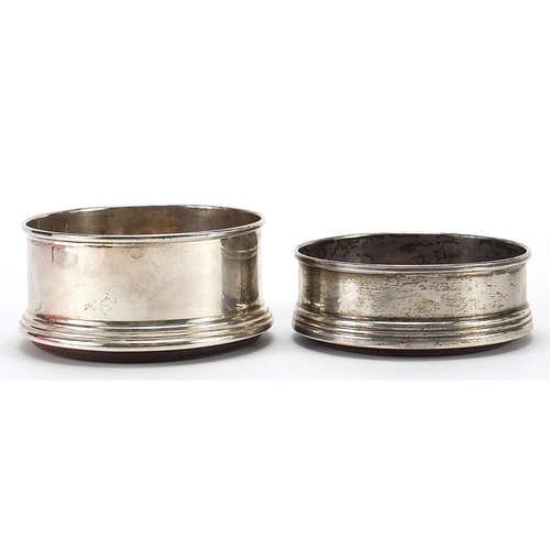 139 - Two circular silver and oak wine coasters, the largest 9cm in diameter, total weight 196.2g