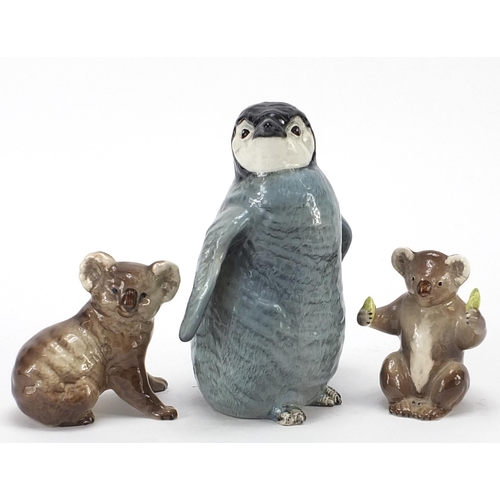 396 - Beswick animals comprising baby Emperor penguin and two koalas, the largest 17cm high