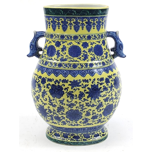 443 - Large Chinese blue and yellow porcelain vase with twin handles hand painted with flower heads amongs... 