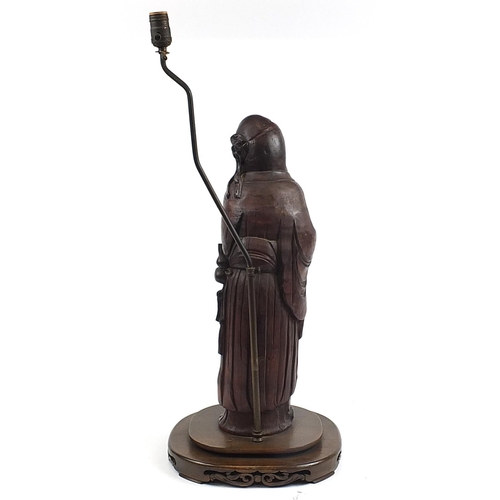 452 - Chinese carved foot wood floor standing lamp in the form of an Elder holding fruit, 82cm high