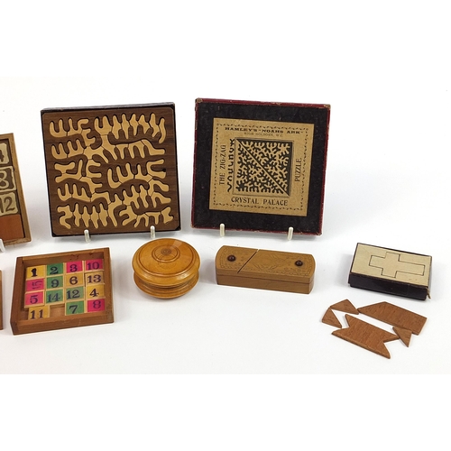 612 - Selection of Victorian and later treen dexterity puzzles including The Zig Zag Crystal Palace puzzle... 