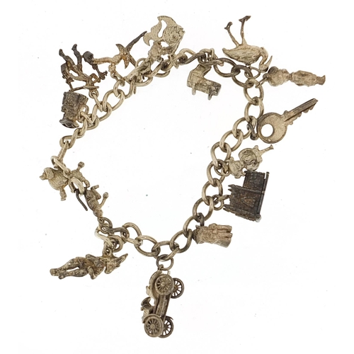 930 - Silver charm bracelet with a selection of mostly silver charms, 51.4g