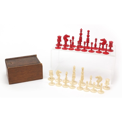 615 - Half stained carved ivory chess set with pine case, the largest pieces each 6.5cm high