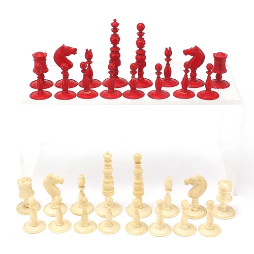 615 - Half stained carved ivory chess set with pine case, the largest pieces each 6.5cm high