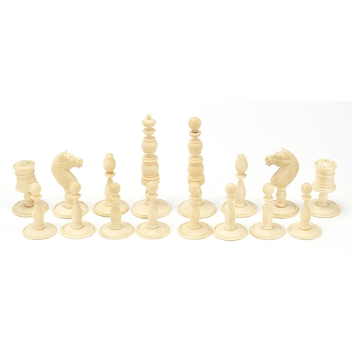 615 - Half stained carved ivory chess set with pine case, the largest pieces each 6.5cm high