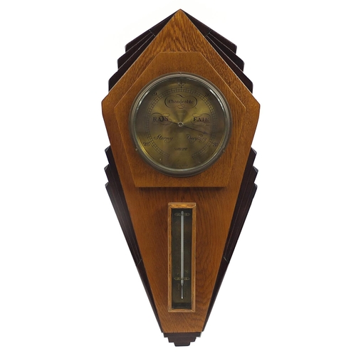 129 - Art Deco carved oak wall barometer with thermometer, the circular dial impressed R A Jones & Sons of... 