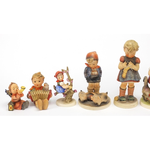 591 - Nine Goebel Hummel figures, the largest 17cm high