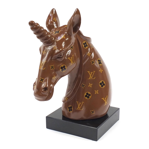 453 - Louis Vuitton design bust of a unicorn raised on a square black glass base, 47cm high
