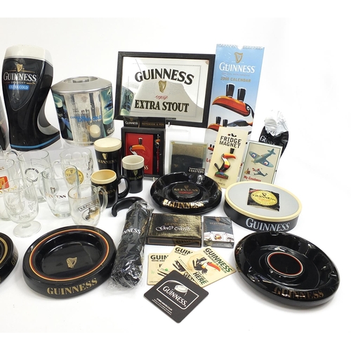 180A - Large collection of Guinness advertising breweriana including glasses, ashtrays, album of postcards,... 