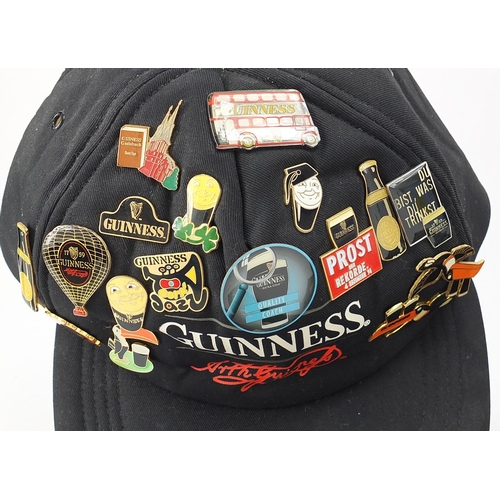 179 - Vintage and later Guinness advertising badges and set of six buttons, some arranged on a flat cap