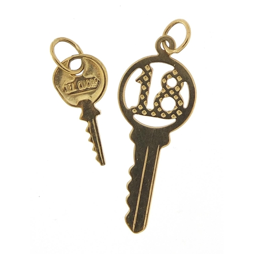 968 - Two unmarked gold key charms including no 18, the largest 2.5cm in length, total 0.7g