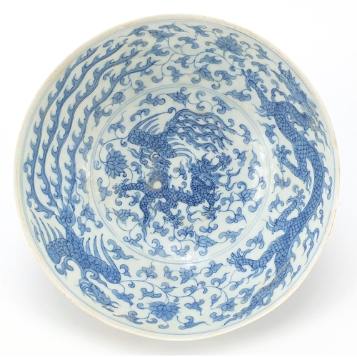 303 - Chinese blue and white porcelain bowl hand painted with dragons and phoenixes amongst flowers, six f... 