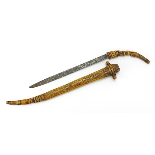 106 - Tribal interest bone sword with and engraved blade, carved figural handle and carved sheath, 45.5cm ... 