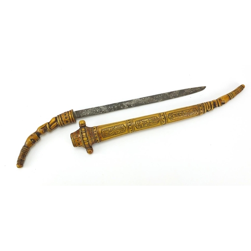 106 - Tribal interest bone sword with and engraved blade, carved figural handle and carved sheath, 45.5cm ... 