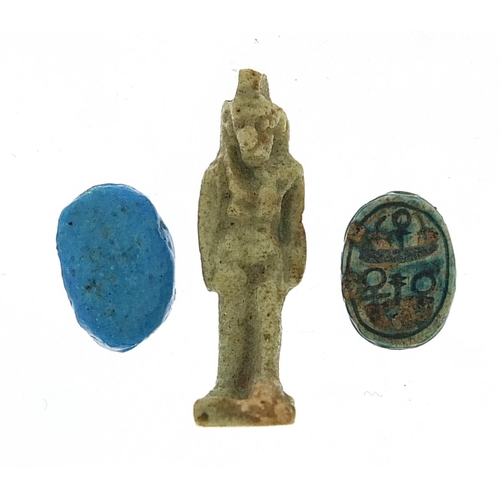 178 - Two Egyptian faience glazed scarab beetle beads and an Isis amulet, the largest 2.5cm high