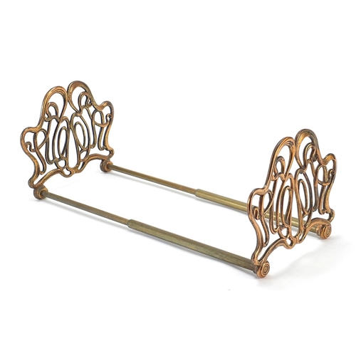 326 - Art Nouveau coppered brass sliding book rack, 21cm adjusting to 36cm