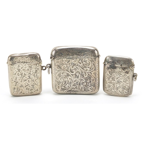 95 - Three Edwardian and later silver vestas with engraved decoration, the largest 5.5cm wide, total weig... 