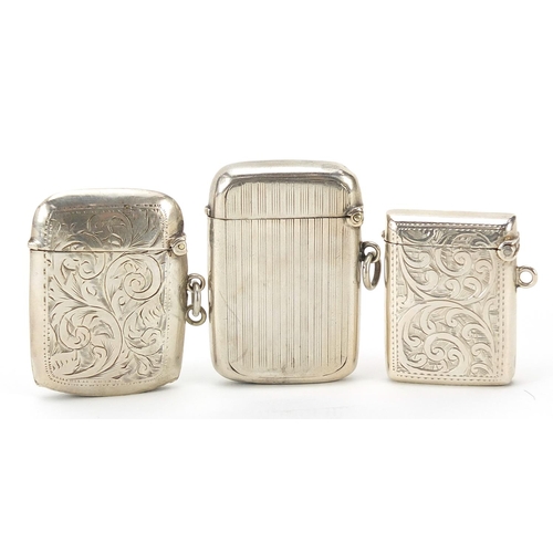 255 - Three Edwardian and later silver vestas with engraved and engine turned decoration, the largest 5cm ... 