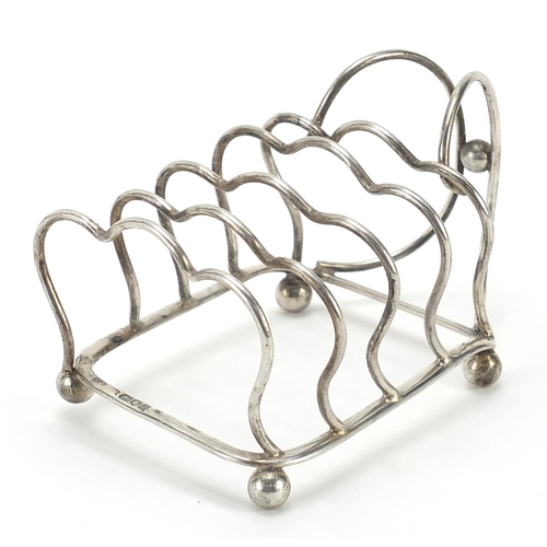 92 - George Unite & Sons, Edward VII silver four slice toast rack with ball feet, London 1904, 12cm in le... 