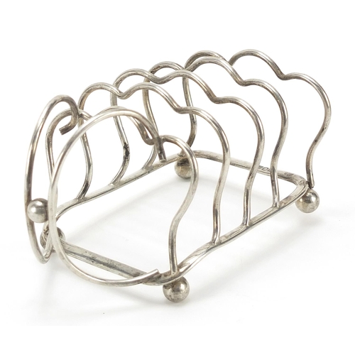 92 - George Unite & Sons, Edward VII silver four slice toast rack with ball feet, London 1904, 12cm in le... 