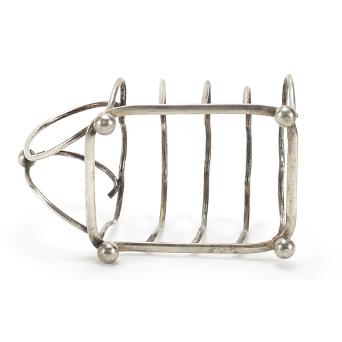 92 - George Unite & Sons, Edward VII silver four slice toast rack with ball feet, London 1904, 12cm in le... 