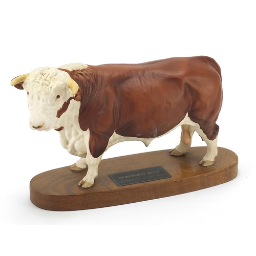 393 - Large Beswick Connoisseur Hereford bull raised on a wood plinth base, 30cm in length