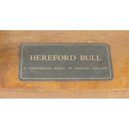 393 - Large Beswick Connoisseur Hereford bull raised on a wood plinth base, 30cm in length