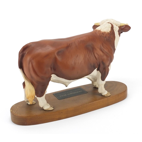 393 - Large Beswick Connoisseur Hereford bull raised on a wood plinth base, 30cm in length