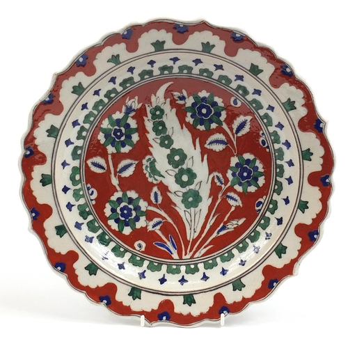 103 - Turkish Iznik pottery plate hand painted with flowers, 32cm in diameter