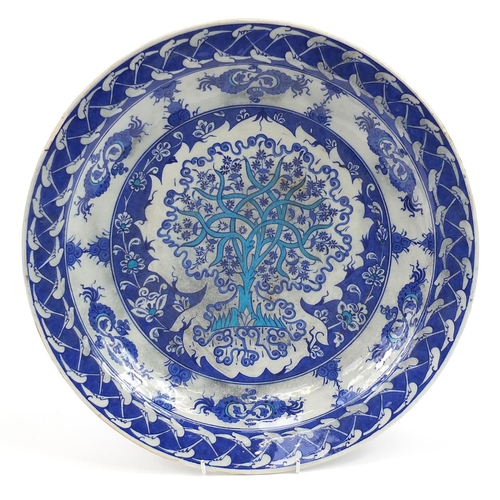 167 - Turkish Iznik pottery charger hand painted with stylised tree amongst flowers, 41cm in diameter