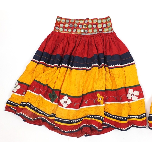 174 - Two Middle Eastern or Indian mirrored embroidered skirts, possibly Banjara tribe, each 83cm high