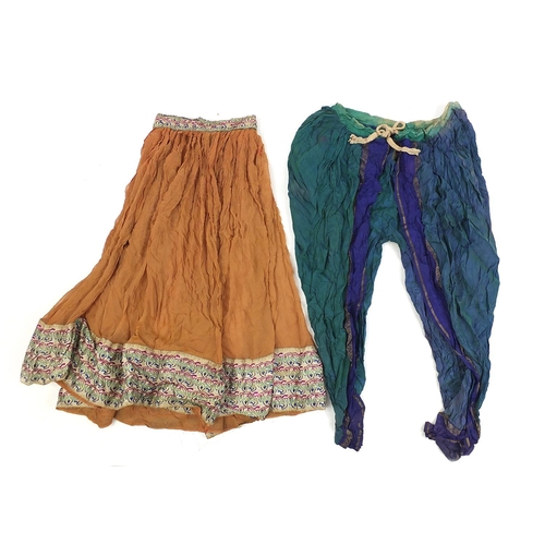 111 - Middle Eastern and Indian textiles including an embroidered skirt, Palestinian style hanging, two si... 